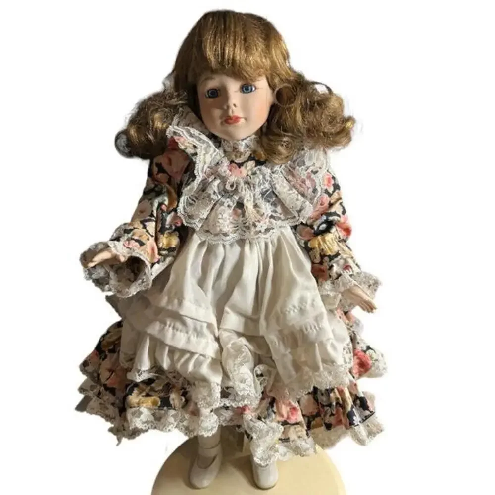 18” porcelain doll with flower dress and brown hair